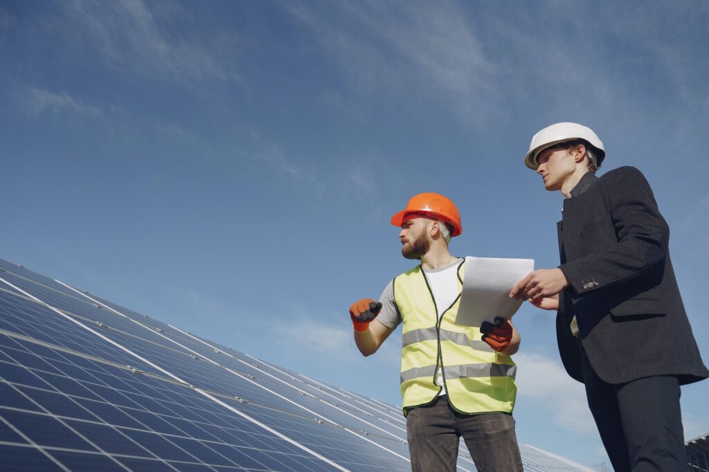 Foreman and businessman at solar energy station